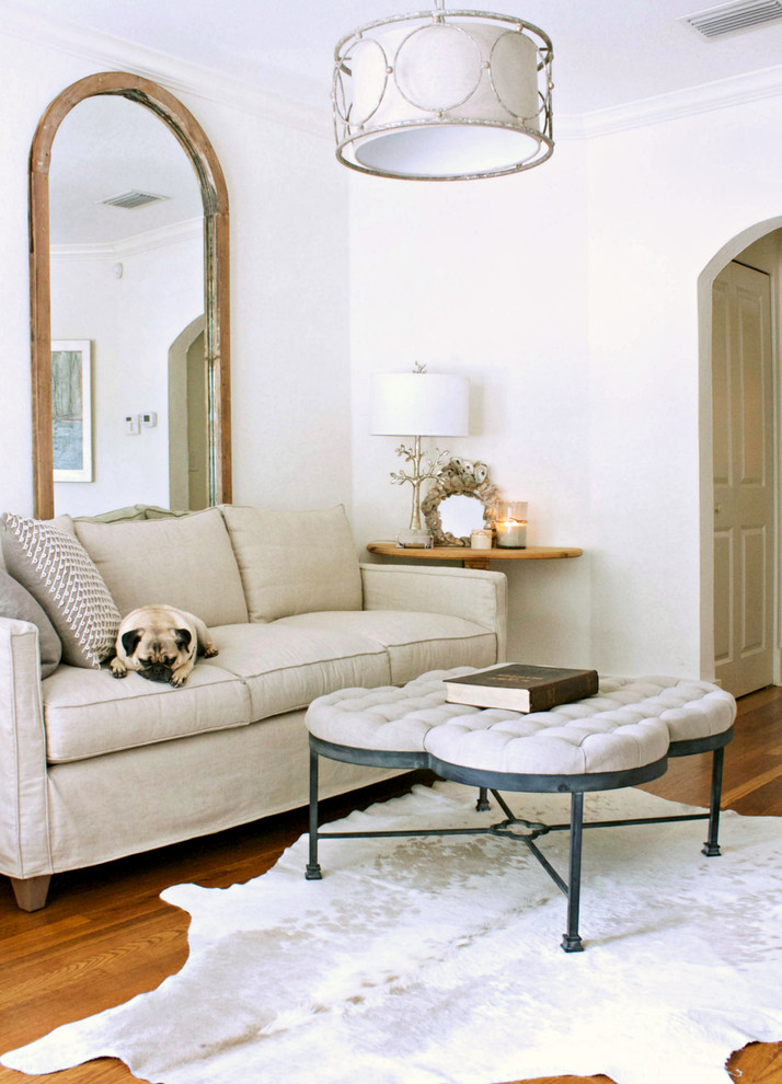 Photo of a transitional living room in Tampa with white walls and medium hardwood floors.