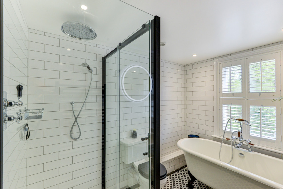 Mid-sized ornate kids' white tile and ceramic tile ceramic tile, multicolored floor and single-sink bathroom photo in Sussex with a two-piece toilet, white walls, a pedestal sink, tile countertops and black countertops