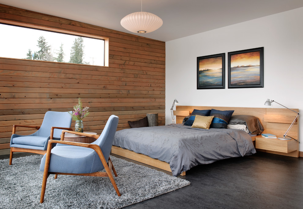 Photo of an industrial bedroom in Seattle with concrete floors and grey floor.