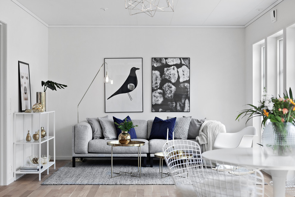Photo of a small scandinavian formal open concept living room in Other with white walls, medium hardwood floors, no fireplace and beige floor.