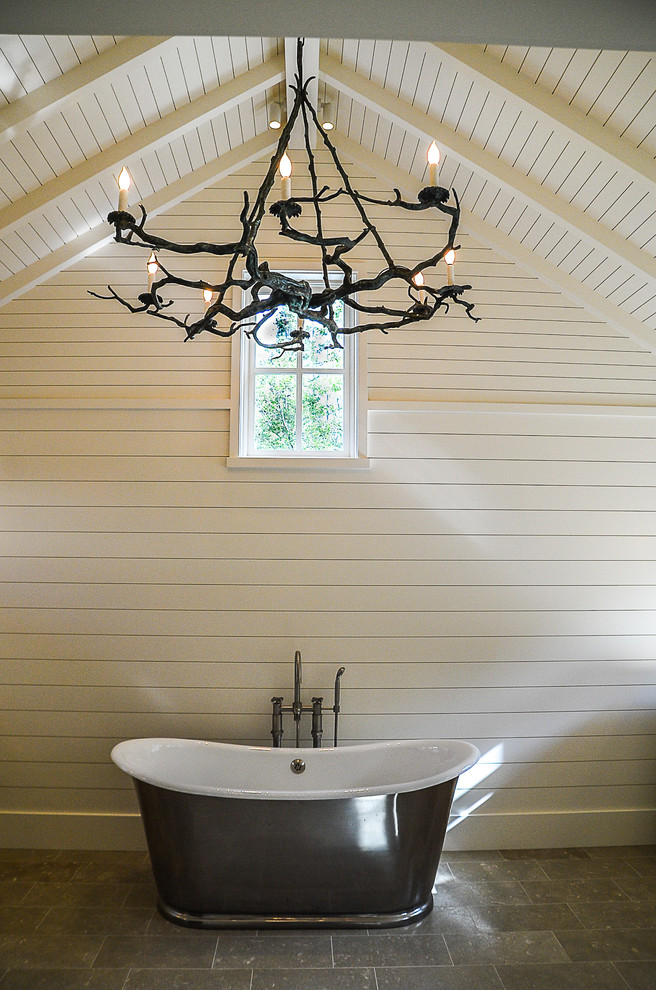Country bathroom in San Francisco with a freestanding tub, white walls, slate floors and grey floor.
