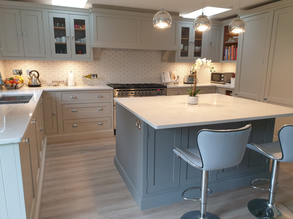 Traditional kitchen/diner in Surrey with a double-bowl sink, beaded cabinets, beige cabinets and an island.