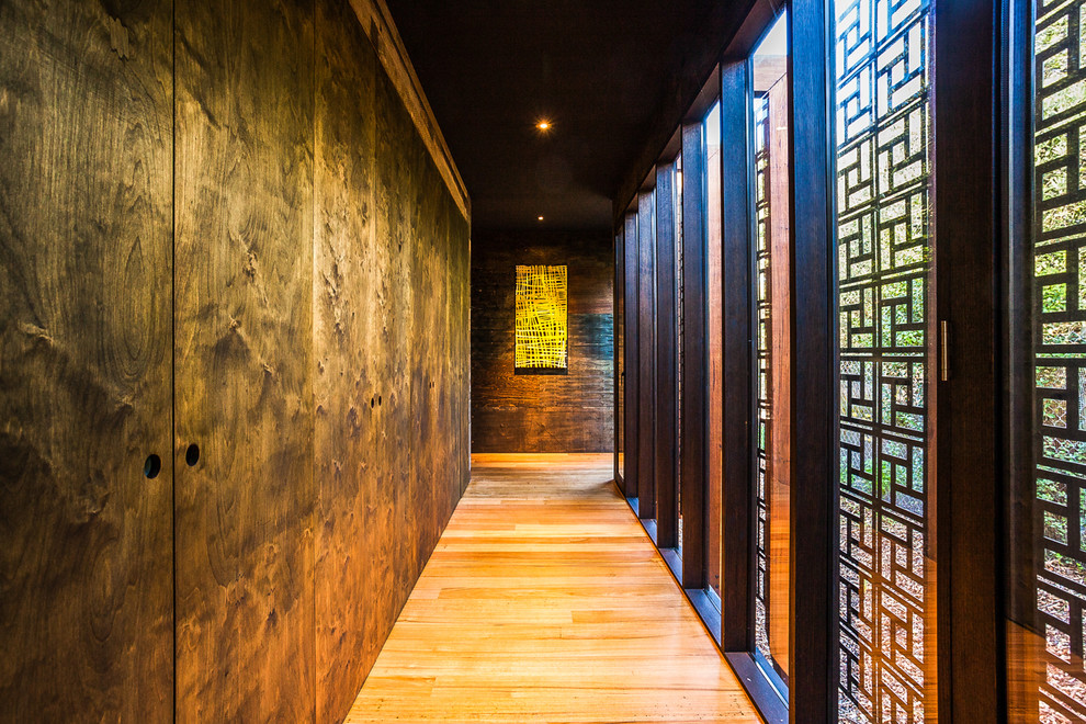 This is an example of a mid-sized asian hallway in Melbourne with light hardwood floors.