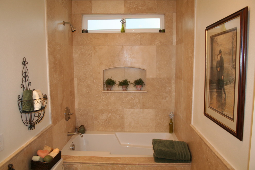 Photo of a mid-sized traditional master bathroom in Orange County with raised-panel cabinets, dark wood cabinets, an alcove tub, a shower/bathtub combo, beige tile, limestone, beige walls, limestone floors, an undermount sink and granite benchtops.