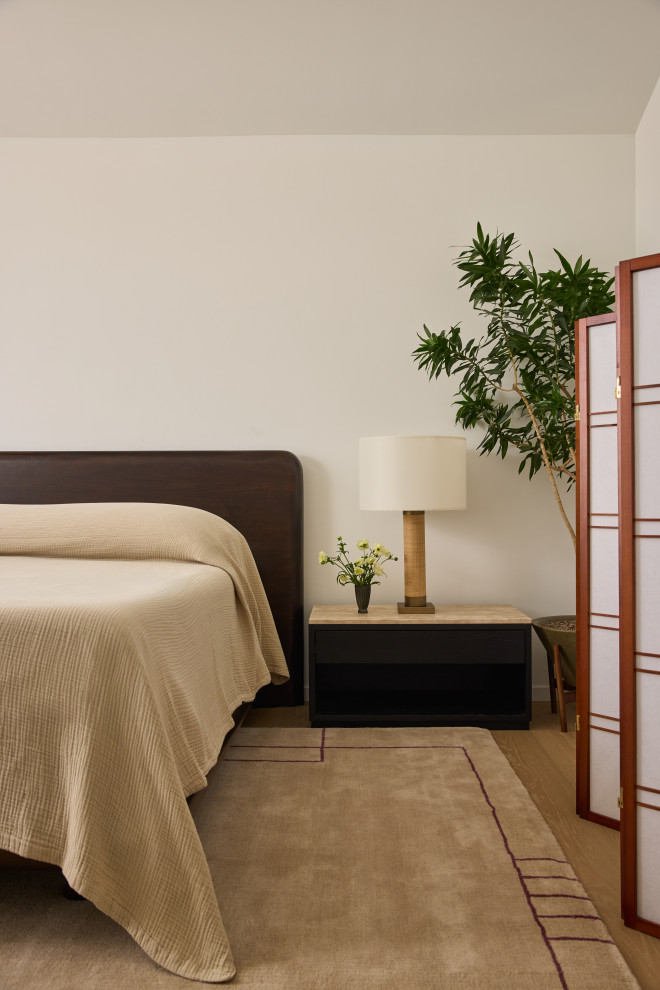 Zen light wood floor and beige floor bedroom photo in Orange County with white walls