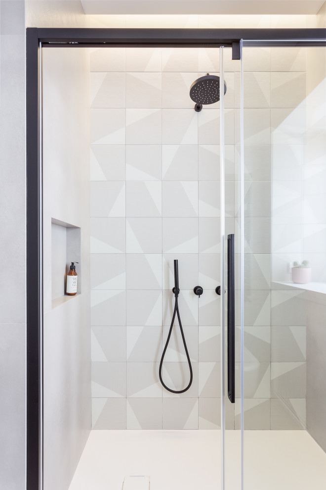 This is an example of a mid-sized scandinavian powder room in Rome with gray tile.