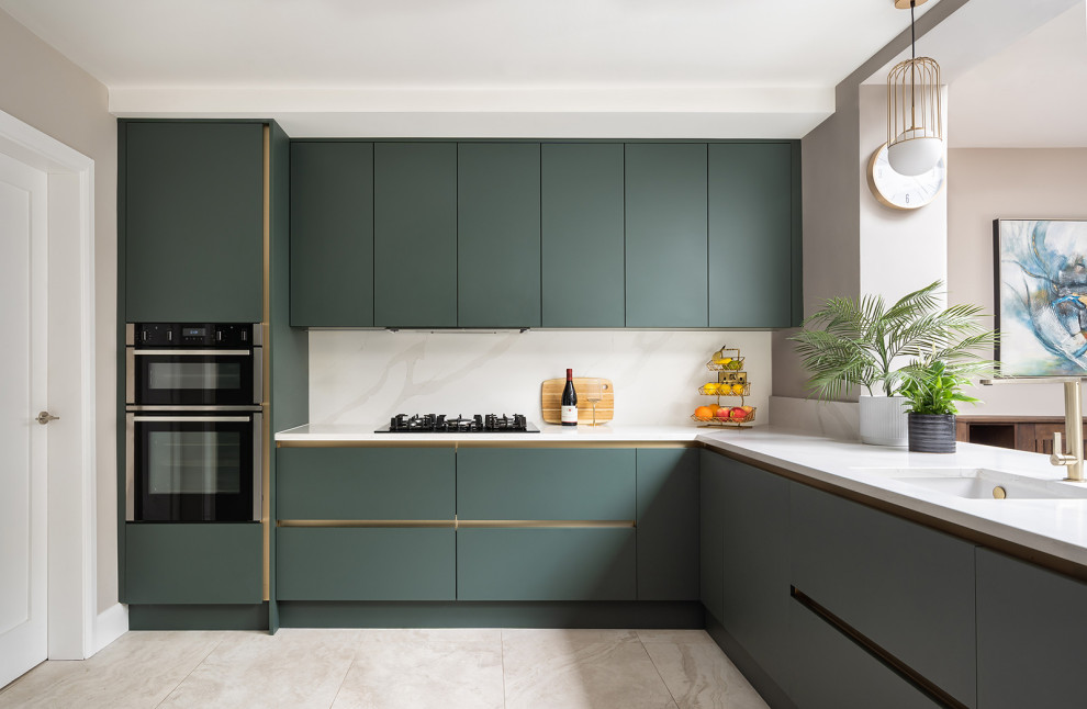 Design ideas for a mid-sized contemporary l-shaped open plan kitchen in Dublin with an integrated sink, flat-panel cabinets, green cabinets, quartzite benchtops, white splashback, stainless steel appliances, porcelain floors, with island, beige floor, white benchtop and vaulted.