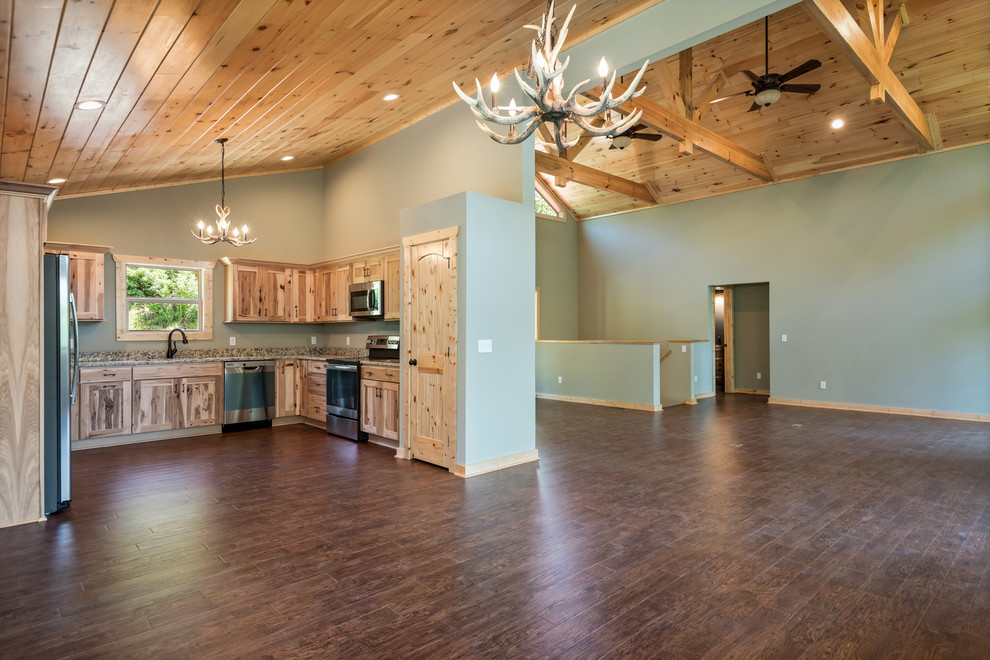 Inspiration for a large rustic u-shaped laminate floor and brown floor eat-in kitchen remodel with a double-bowl sink, recessed-panel cabinets, light wood cabinets, granite countertops, multicolored backsplash, stainless steel appliances, no island and multicolored countertops