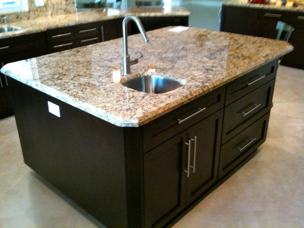 Example of a large transitional u-shaped travertine floor and beige floor open concept kitchen design in Miami with an undermount sink, shaker cabinets, dark wood cabinets, granite countertops, multicolored backsplash, stone tile backsplash, stainless steel appliances and an island