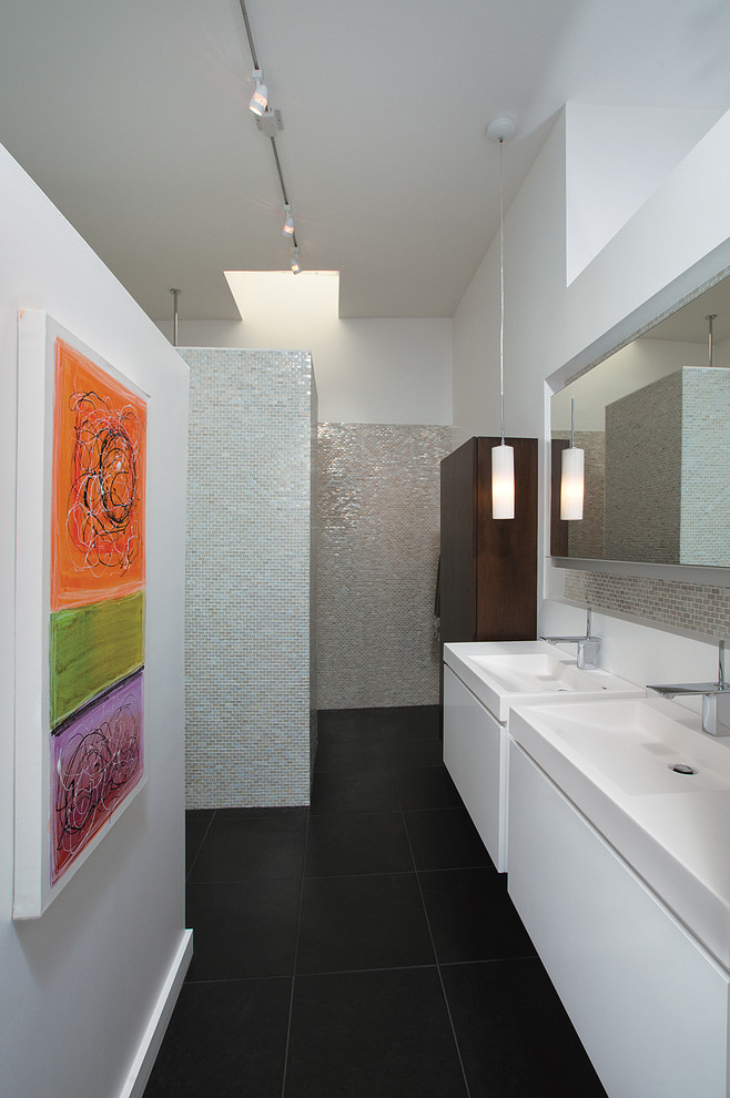 Photo of a midcentury bathroom in Atlanta with mosaic tile.