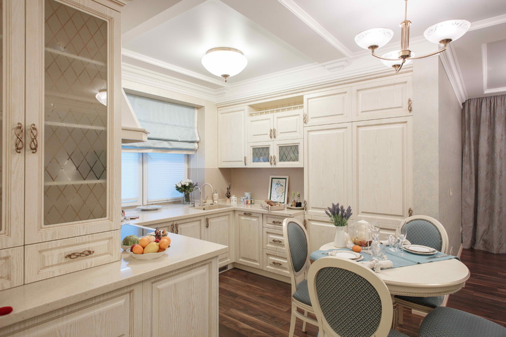 Design ideas for a traditional u-shaped kitchen in Other with raised-panel cabinets, beige cabinets, no island, an undermount sink and medium hardwood floors.