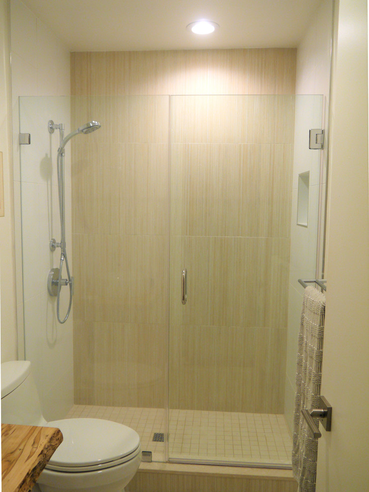 This is an example of a small beach style 3/4 bathroom in DC Metro with open cabinets, light wood cabinets, an alcove shower, a one-piece toilet, beige tile, porcelain tile, white walls, porcelain floors, a pedestal sink, wood benchtops, beige floor, a hinged shower door and brown benchtops.