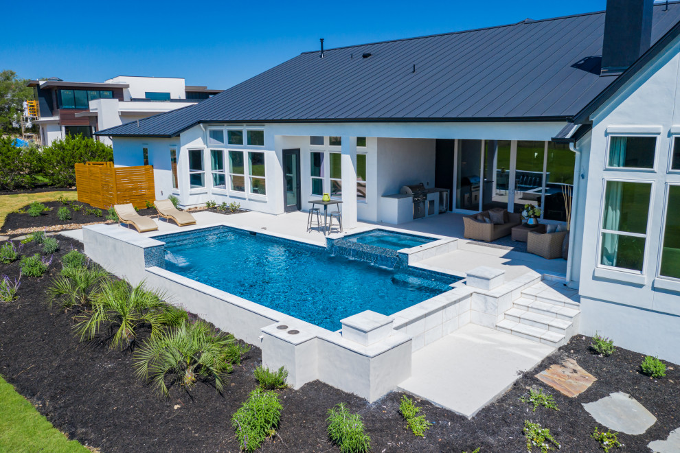 Design ideas for a large modern back custom shaped swimming pool in Other with decking.