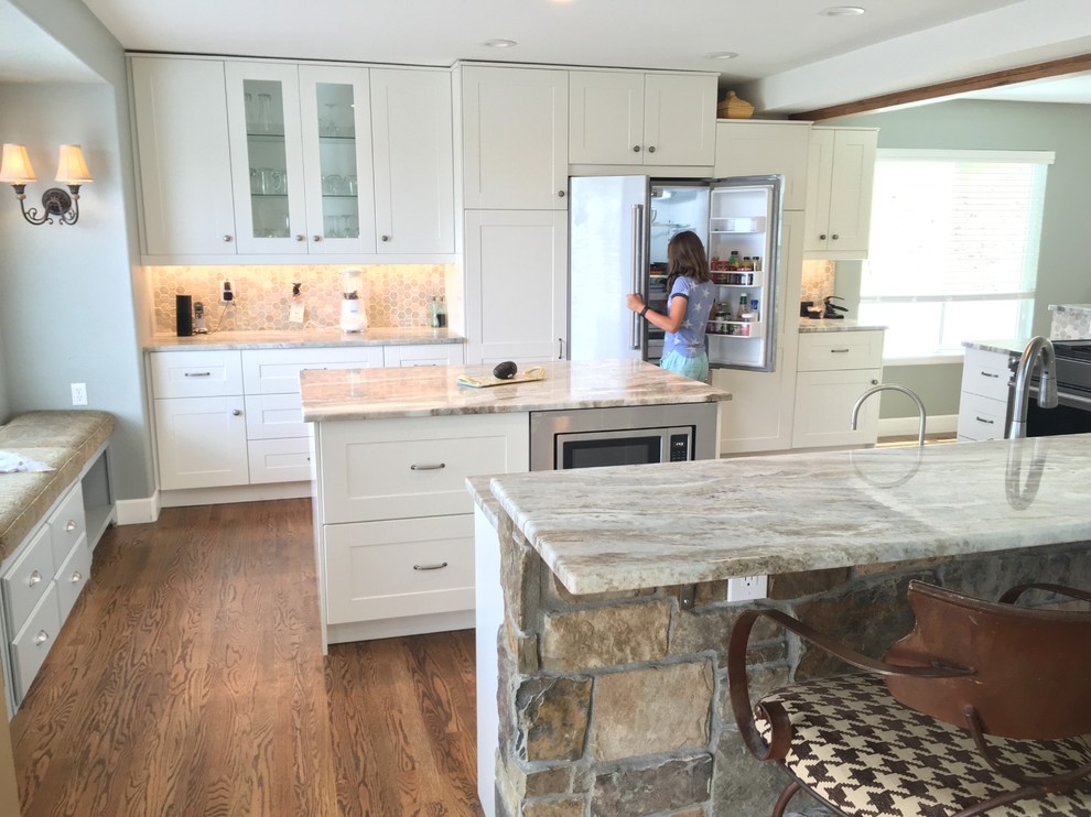 Example of a large transitional eat-in kitchen design in Denver with a farmhouse sink, medium tone wood cabinets, stainless steel appliances and an island