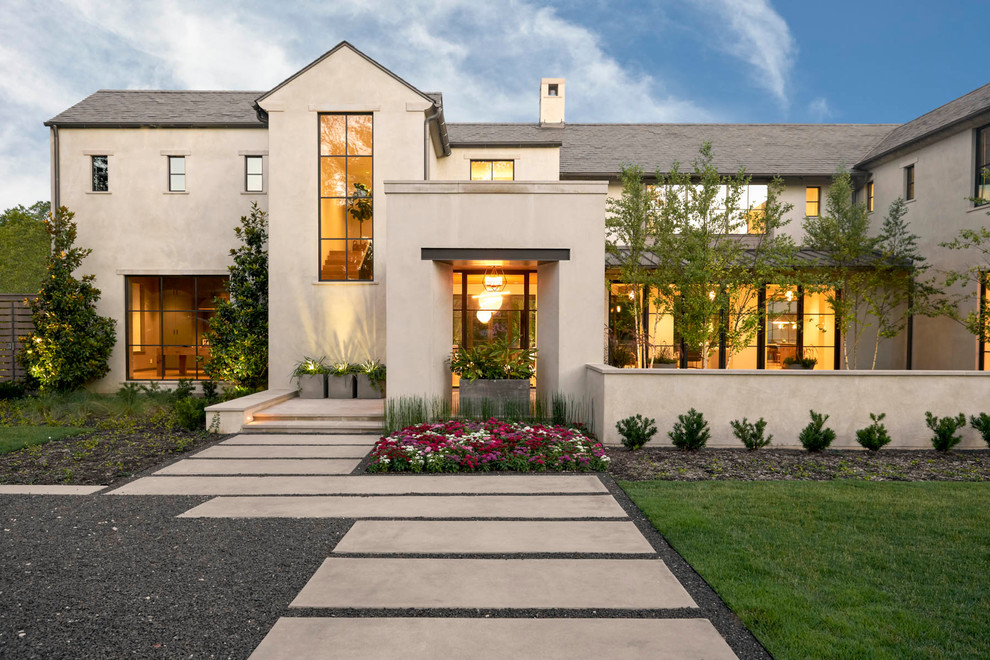 Inspiration for a transitional two-storey beige house exterior in Dallas.
