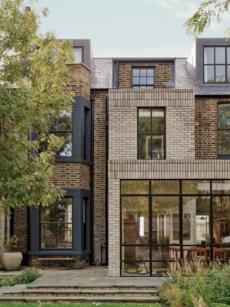 ロンドンにあるトラディショナルスタイルのおしゃれな家の外観 (レンガサイディング、デュープレックス) の写真