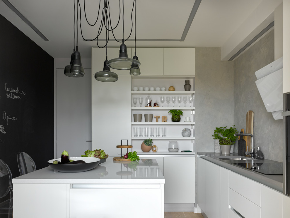 This is an example of a contemporary l-shaped separate kitchen in Moscow with an undermount sink, flat-panel cabinets, white cabinets, grey splashback, light hardwood floors and with island.