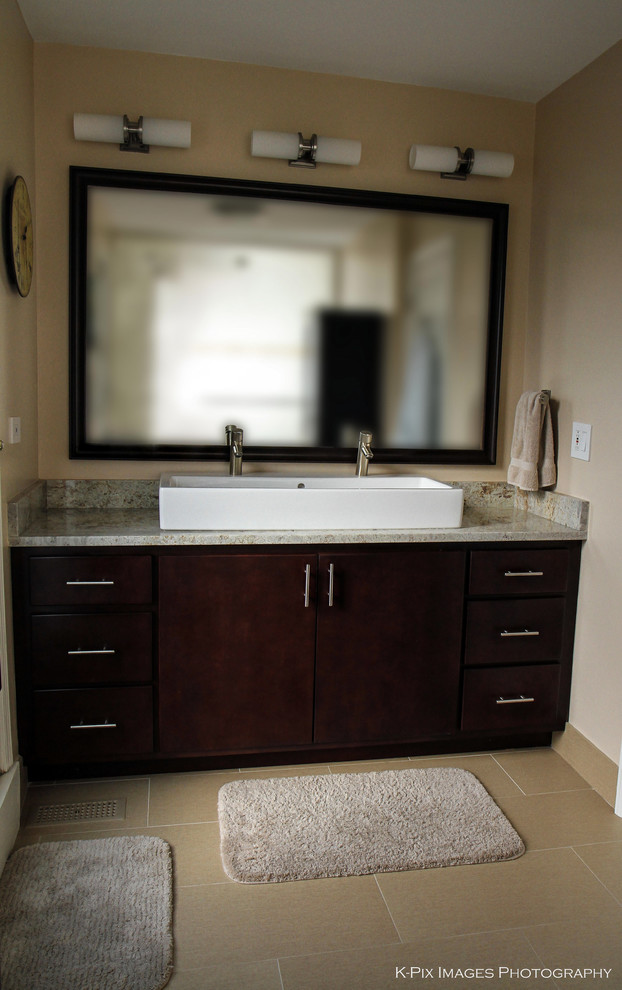 Inspiration for a large transitional master beige tile and porcelain tile porcelain tile doorless shower remodel in Chicago with an integrated sink, flat-panel cabinets, dark wood cabinets, granite countertops, a one-piece toilet and beige walls
