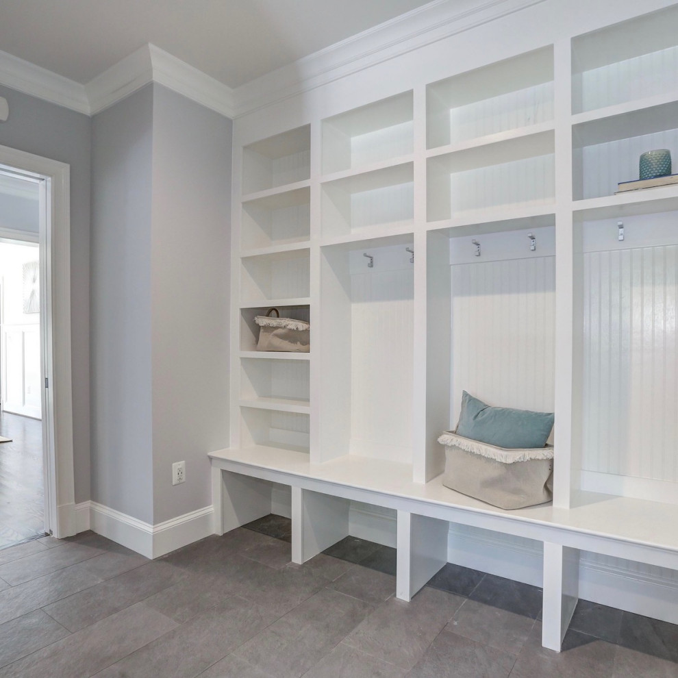 Photo of a country mudroom in DC Metro with porcelain floors.