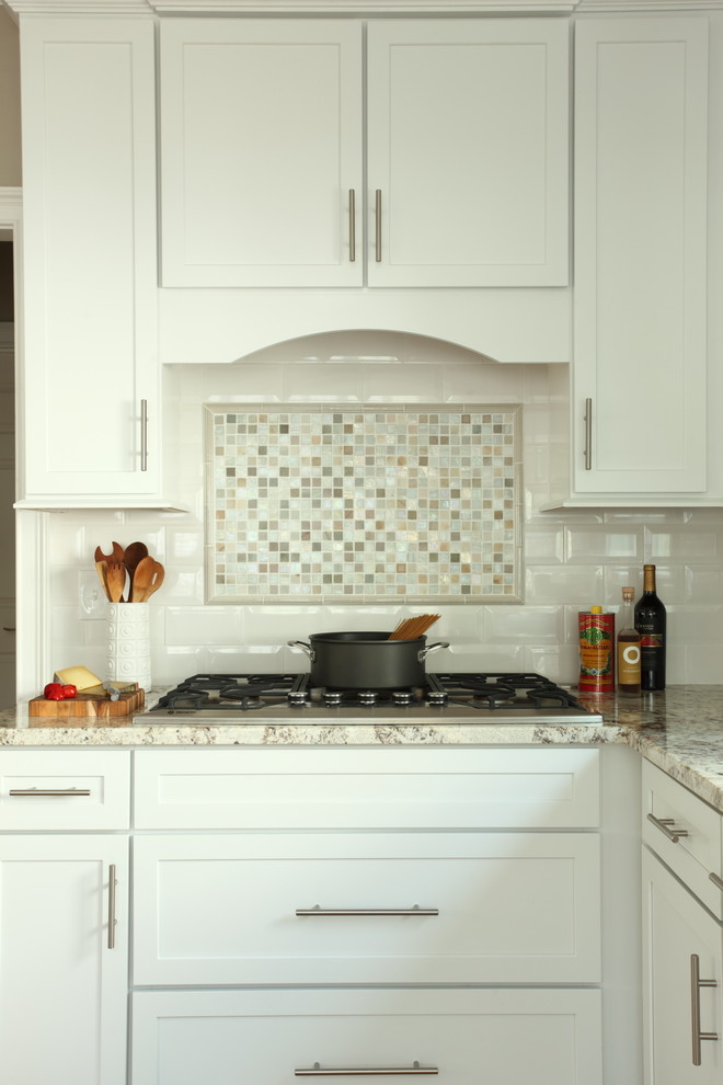 Enclosed kitchen - small transitional l-shaped enclosed kitchen idea with shaker cabinets, white cabinets, granite countertops, white backsplash, subway tile backsplash, stainless steel appliances and no island
