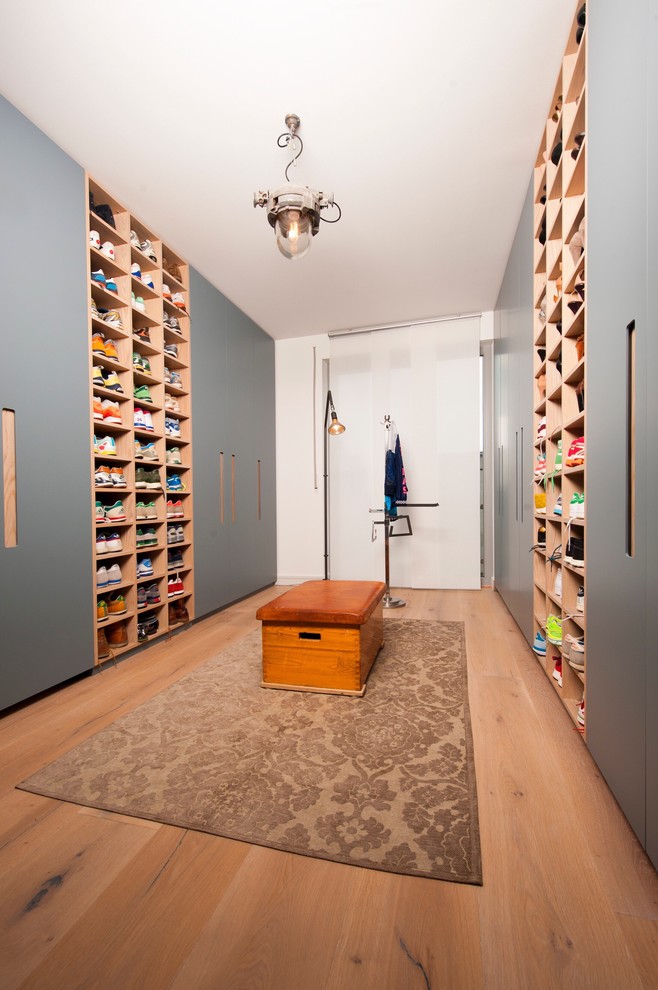 Expansive country gender-neutral built-in wardrobe in Dusseldorf with laminate floors.