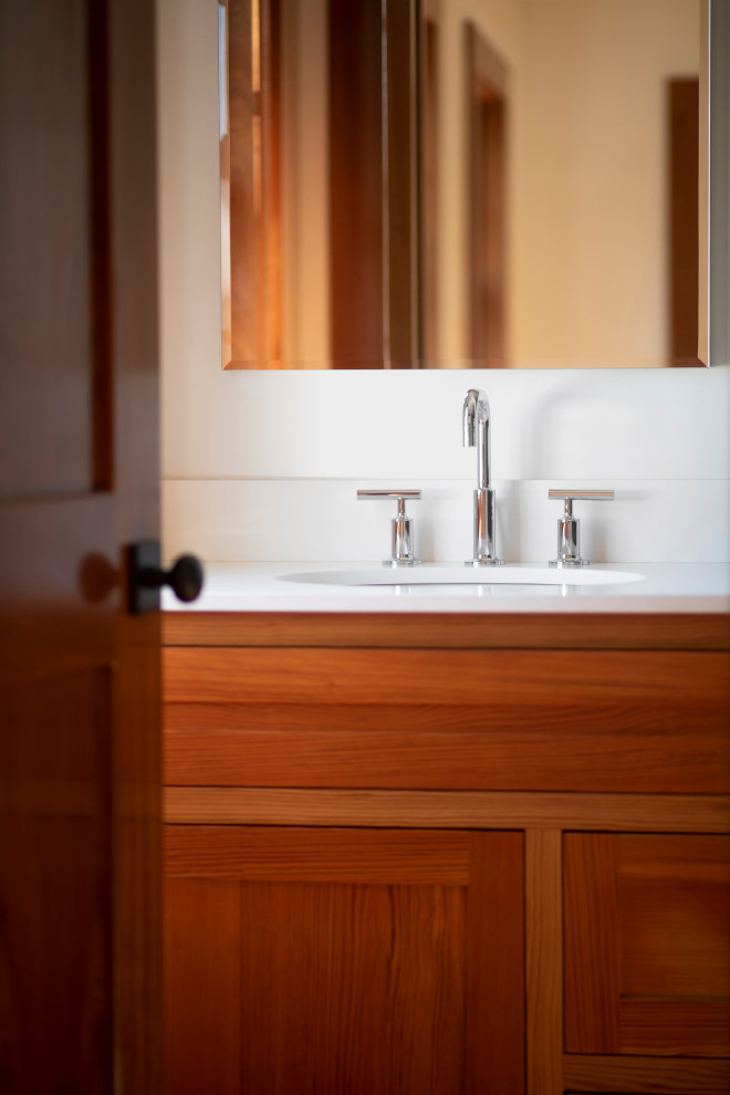 This is an example of a mid-sized master bathroom in Miami with shaker cabinets, medium wood cabinets, a one-piece toilet, blue tile, ceramic tile, white walls, medium hardwood floors, an undermount sink, engineered quartz benchtops, a hinged shower door, white benchtops, a niche, a single vanity, a built-in vanity and wood walls.