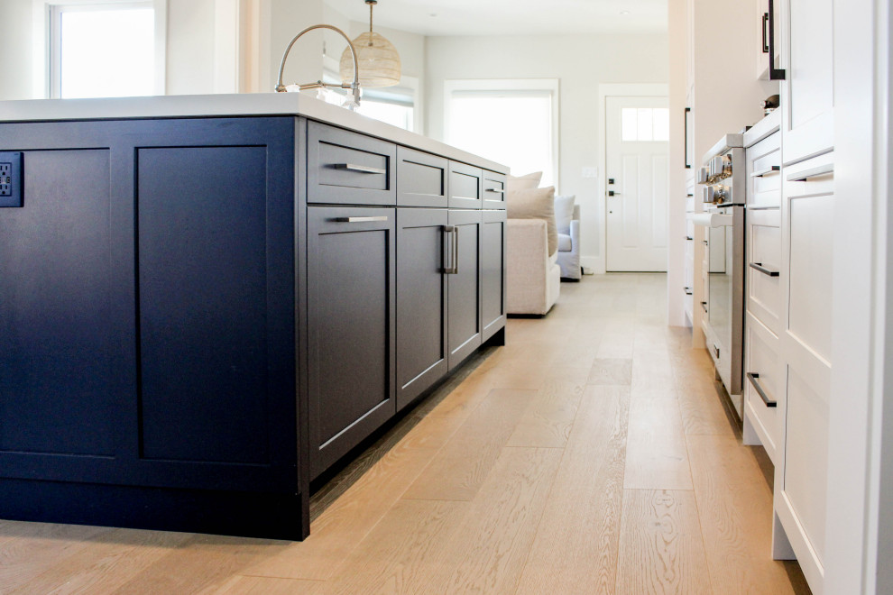 Example of a transitional beige floor kitchen design with white backsplash, subway tile backsplash and white countertops