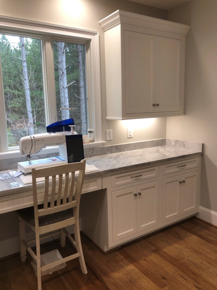 Photo of a classic utility room in Charlotte with recessed-panel cabinets and white cabinets.