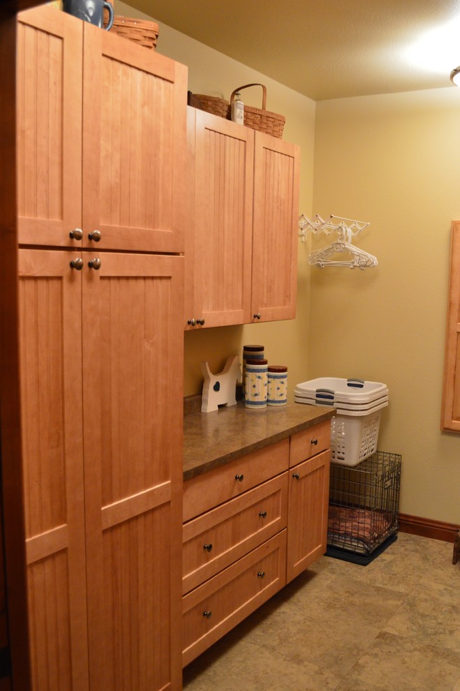 Photo of a mid-sized arts and crafts utility room in Denver with recessed-panel cabinets and medium wood cabinets.