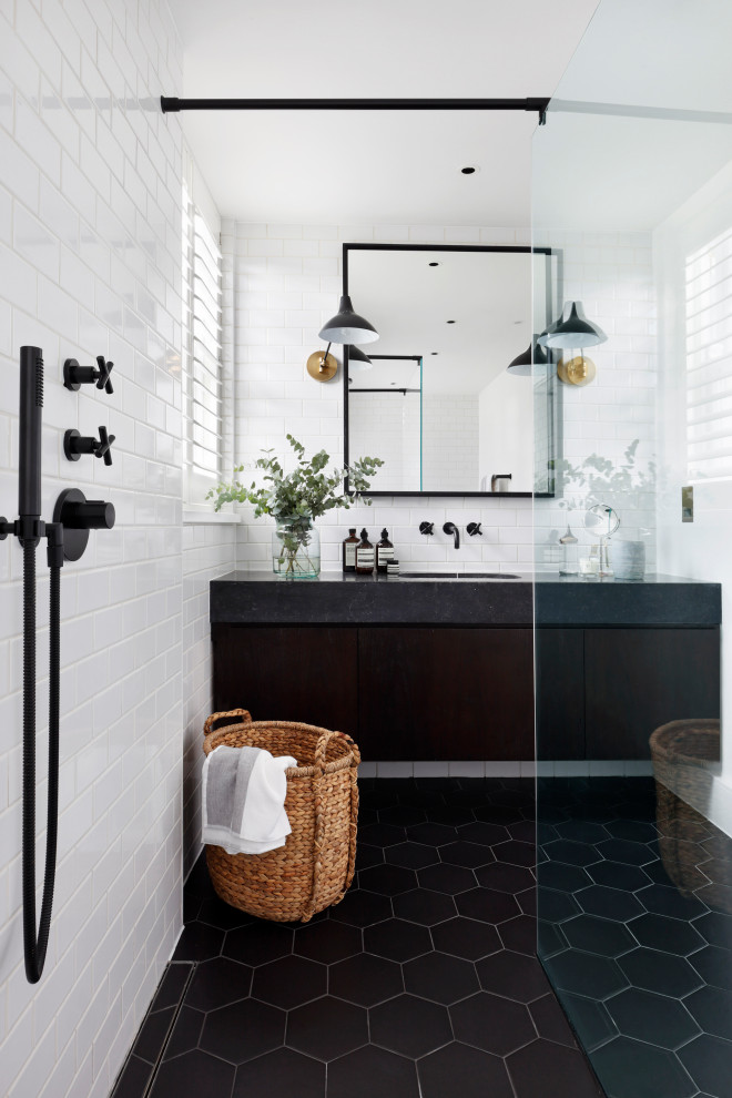 Transitional 3/4 bathroom in London with flat-panel cabinets, dark wood cabinets, a curbless shower, white tile, subway tile, an undermount sink, an open shower, black benchtops, a single vanity and a floating vanity.
