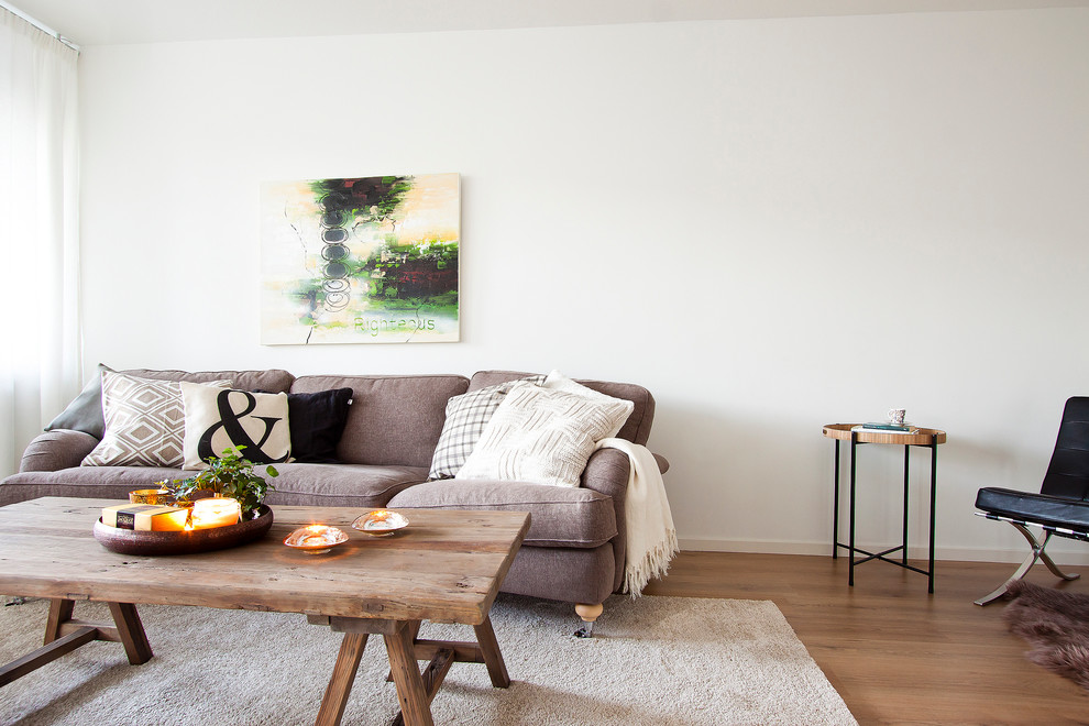 Inspiration for a large scandinavian formal open concept living room in Stockholm with white walls, medium hardwood floors, no fireplace and no tv.