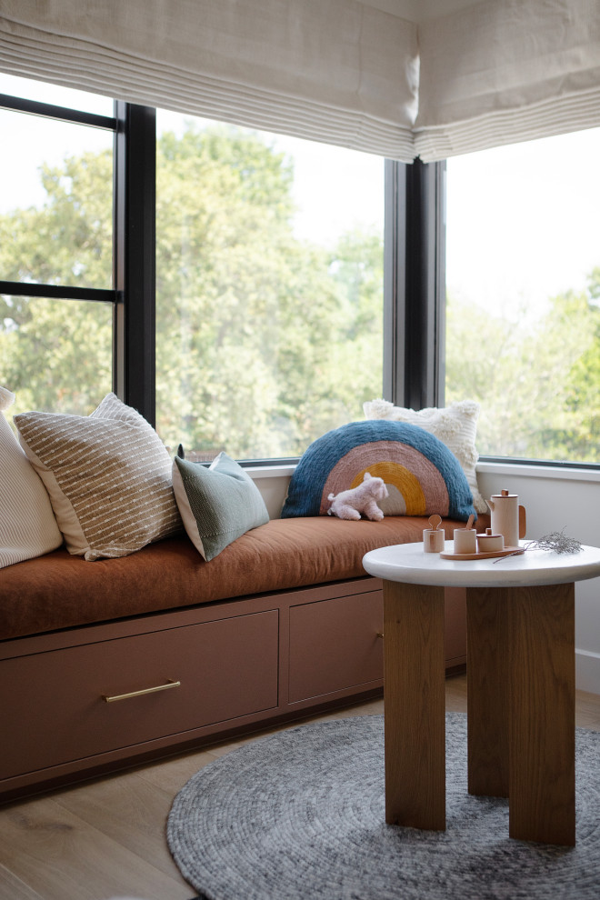 Hill Country Modern Meets Southlake, Texas - This Hill Country Modern home in Southlake combines modern design with comfort, featuring light-filled spaces and unique details reflecting the family's eclectic style for play and sophistication. 

This charming kids' room features cozy bunk beds adorned with soft bedding, a delightful window seat, whimsical lighting, and playful decor, all harmonizing in a serene neutral palette.
