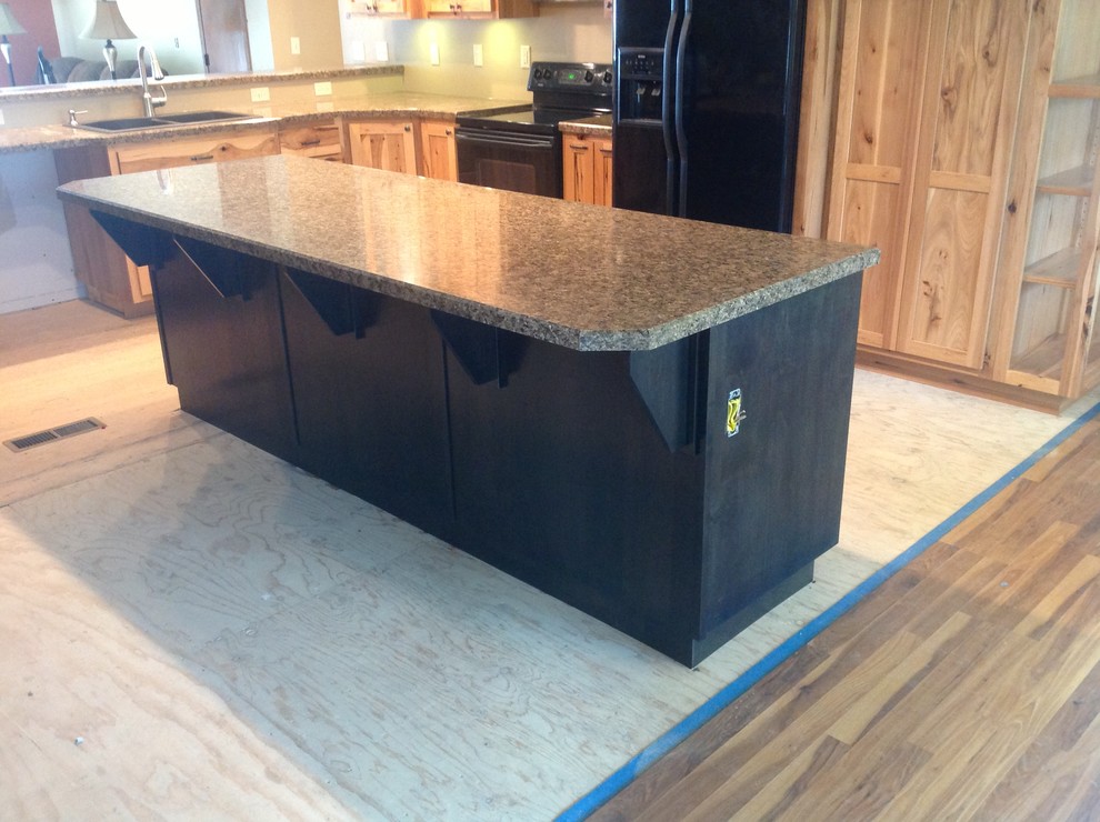 Example of a mid-sized eat-in kitchen design with shaker cabinets, dark wood cabinets, laminate countertops and an island