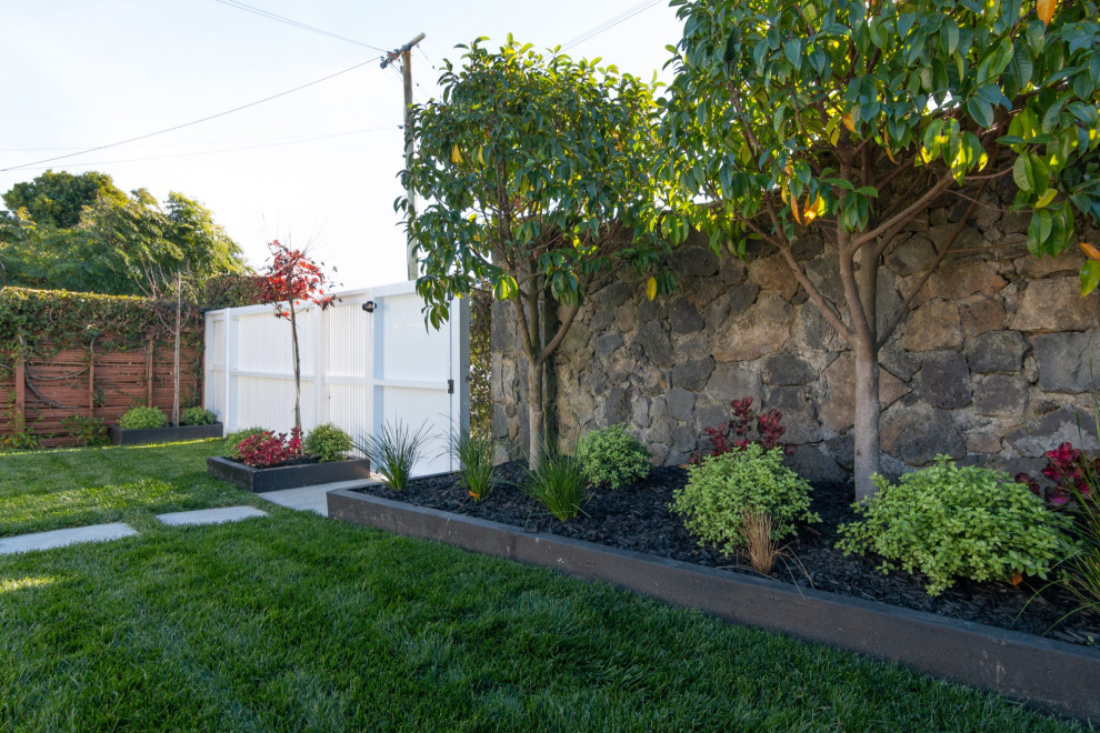 Ispirazione per un giardino formale classico esposto a mezz'ombra davanti casa con cancello, pacciame e recinzione in metallo