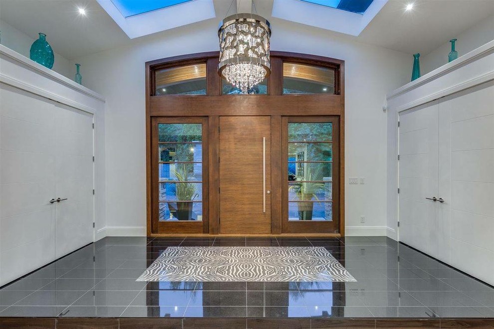 Inspiration for a mid-sized transitional porcelain tile foyer remodel in Phoenix with white walls and a medium wood front door
