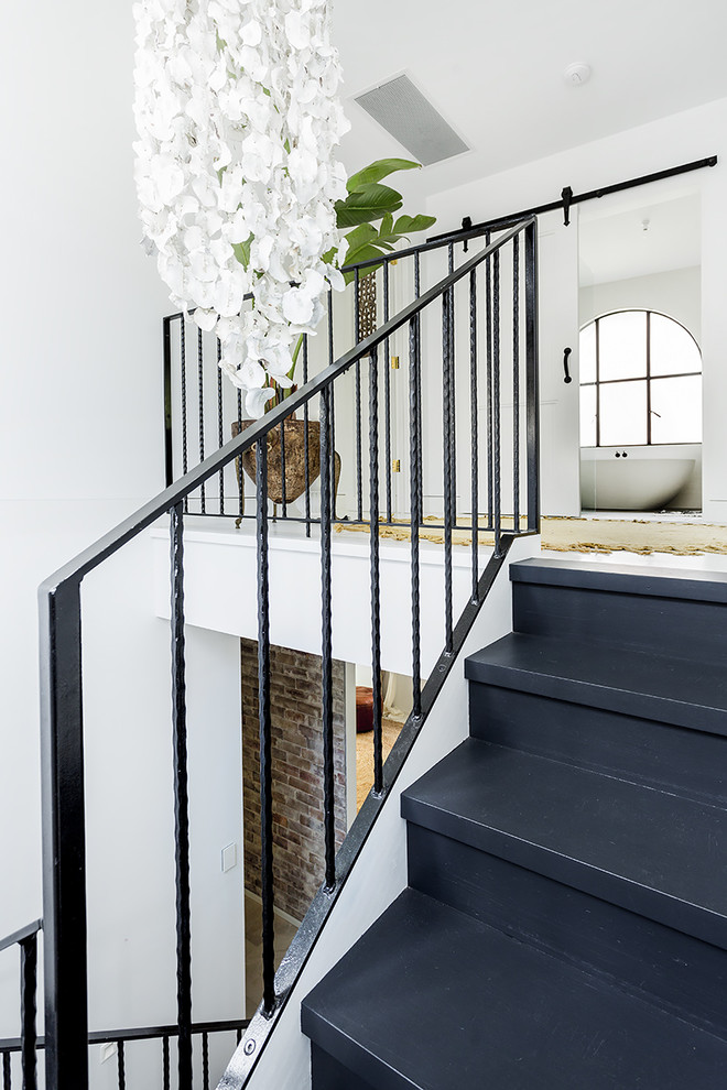 This is an example of a mid-sized scandinavian painted wood u-shaped staircase in Sydney with painted wood risers.