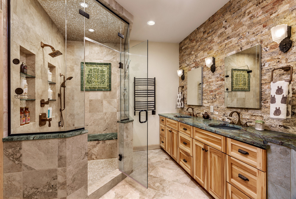 Design ideas for a mid-sized eclectic master bathroom in Milwaukee with flat-panel cabinets, medium wood cabinets, beige tile, marble benchtops, green benchtops, a freestanding tub, an open shower, stone tile, beige walls, travertine floors, an undermount sink, beige floor and an open shower.