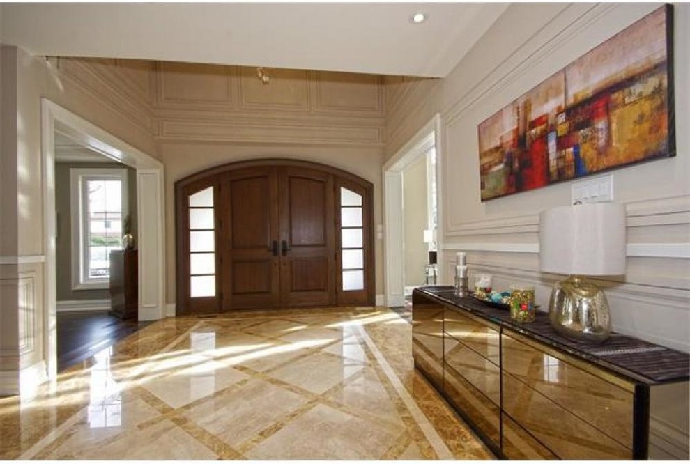 Photo of a mid-sized transitional front door in Toronto with beige walls, marble floors, a double front door, multi-coloured floor and a medium wood front door.