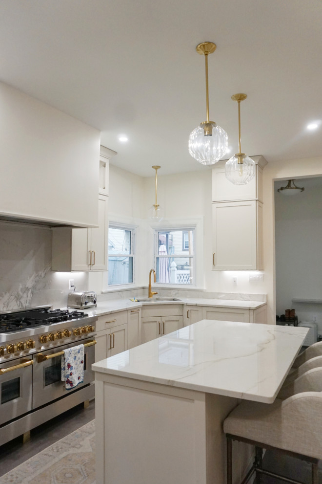 Transitional vinyl floor and gray floor kitchen photo with an undermount sink, shaker cabinets, gray cabinets, quartzite countertops, stone slab backsplash, stainless steel appliances and an island