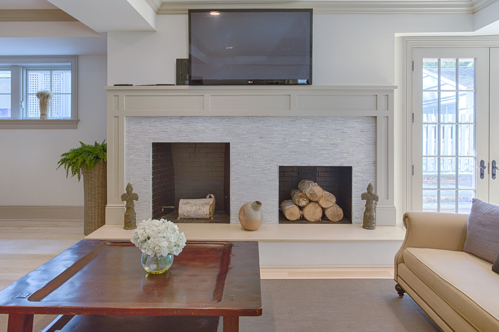 Inspiration for a large traditional walk-out basement in New York with white walls, light hardwood floors, a standard fireplace and a tile fireplace surround.