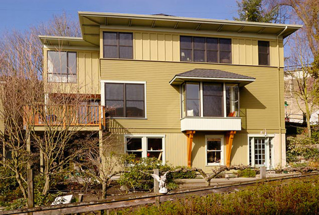 Inspiration for a large transitional green three-story wood exterior home remodel in Seattle