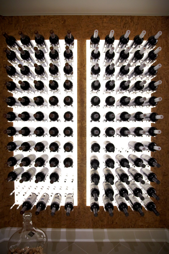 Photo of a large modern wine cellar in New York with storage racks.