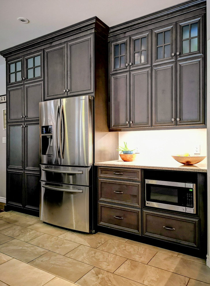 Mid-sized mountain style l-shaped medium tone wood floor and brown floor eat-in kitchen photo with a double-bowl sink, recessed-panel cabinets, dark wood cabinets, granite countertops, stainless steel appliances, an island and gray countertops