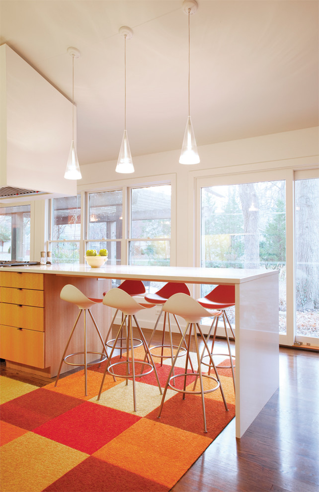 Inspiration for a modern eat-in kitchen in Kansas City with flat-panel cabinets and light wood cabinets.