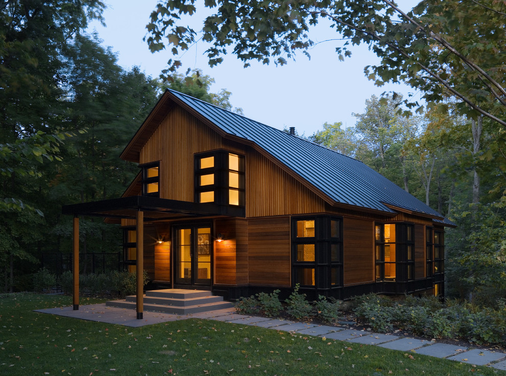 This is an example of a contemporary exterior in Burlington with wood siding and a gable roof.