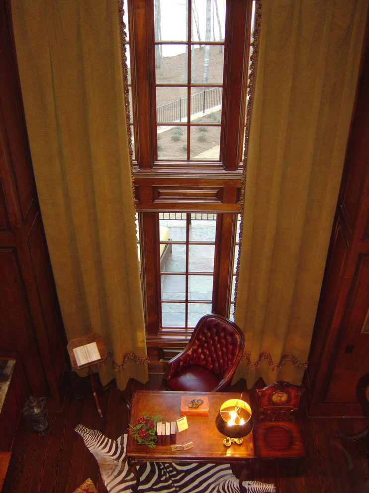 This is an example of a traditional home office in Atlanta with dark hardwood floors and a freestanding desk.