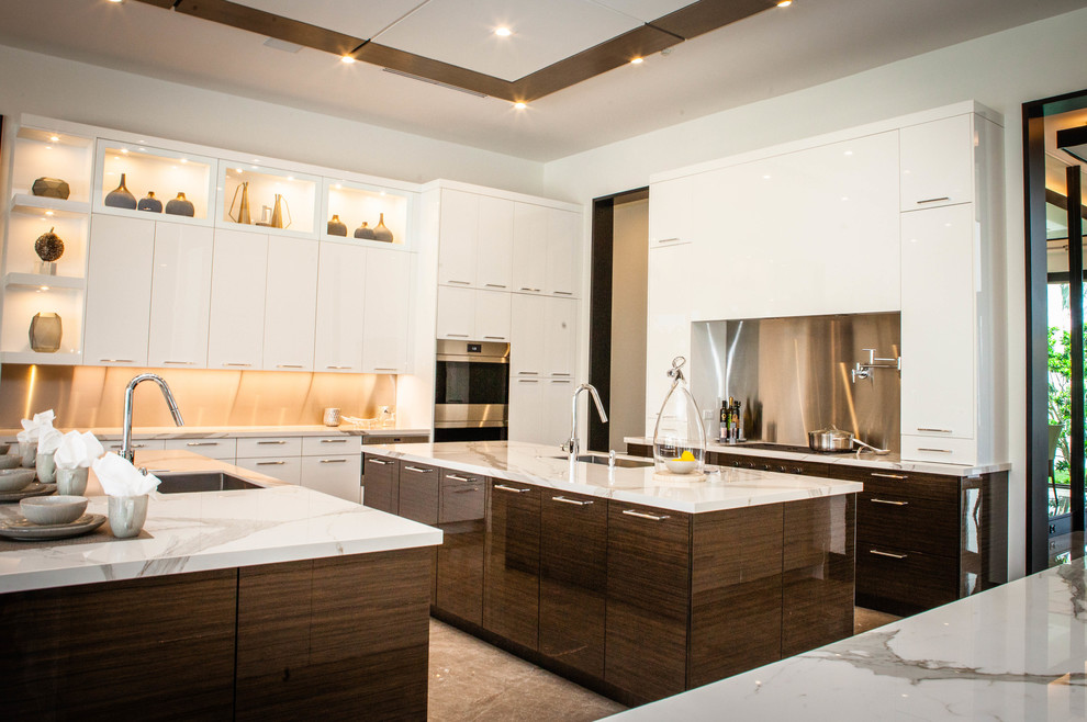 This is an example of a large contemporary l-shaped eat-in kitchen in Miami with an undermount sink, flat-panel cabinets, dark wood cabinets, marble benchtops, stainless steel appliances, marble floors, multiple islands, brown floor and grey benchtop.
