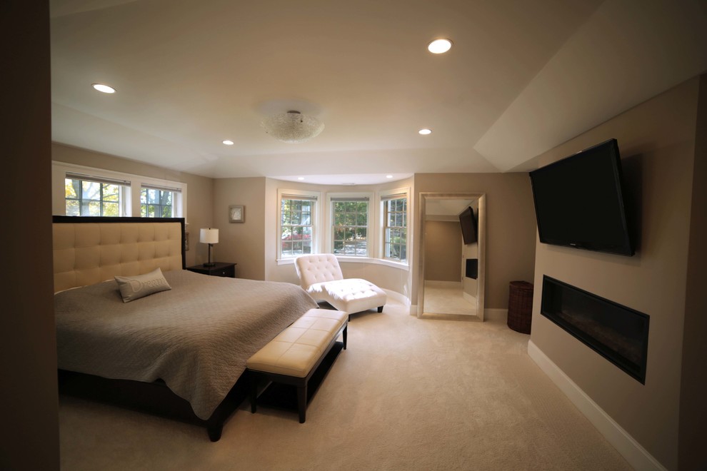 Mid-sized mediterranean master bedroom in Boston with beige walls, carpet, a plaster fireplace surround and a ribbon fireplace.