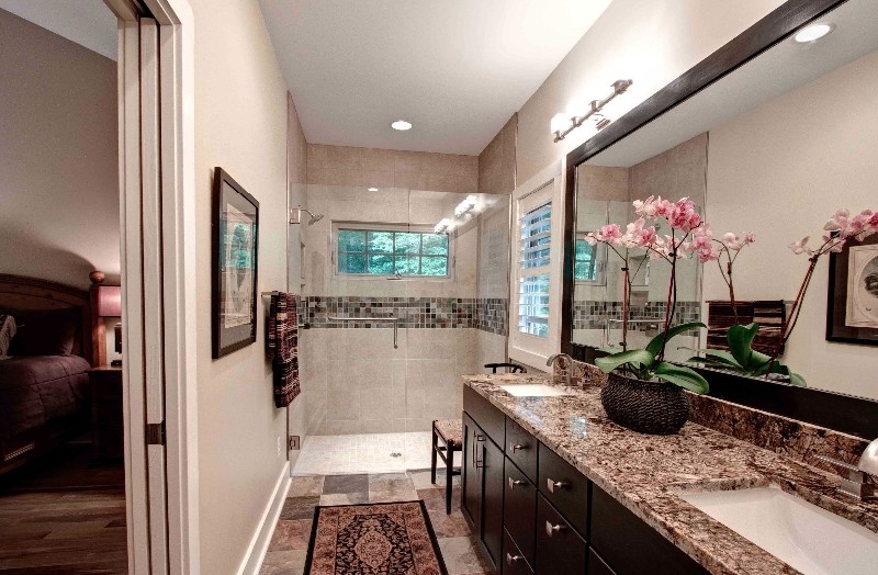 Example of a mid-sized transitional master multicolored tile and ceramic tile alcove shower design with shaker cabinets, black cabinets, granite countertops and an undermount sink