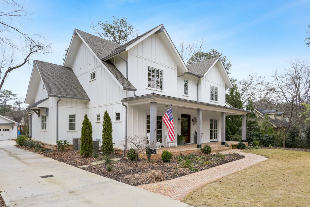 Country two-storey white house exterior in Atlanta with concrete fiberboard siding, a gable roof and a mixed roof.